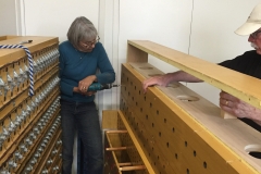 Liz disassembles a wind chest.