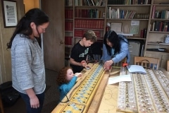 Madeline, Alice, Oliver, and Allison in the final stages of wiring a rank.